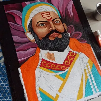 A work-in-progress shot of the Shivaji Maharaj portrait, showing how I build up layers of acrylic paint to create depth and detail in the clothing and expression.