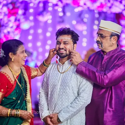 A beautiful, candid moment between the groom and his parents. These lighthearted family interactions are full of love and make for unforgettable photos.