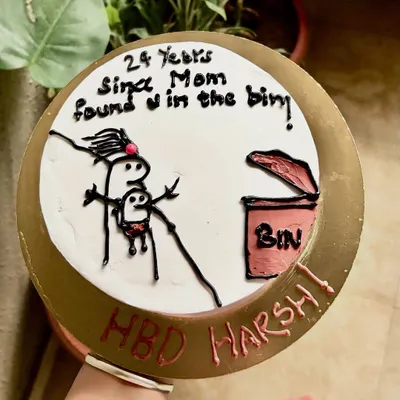 A top-down view of the hilarious "found in the bin" cake. This is for friends with a very specific sense of humor.