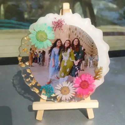 This floral photo frame is perfect for celebrating friendship. I surrounded a picture of three friends with a variety of colorful pressed flowers, creating a vibrant and cheerful keepsake that sits on a small wooden easel.