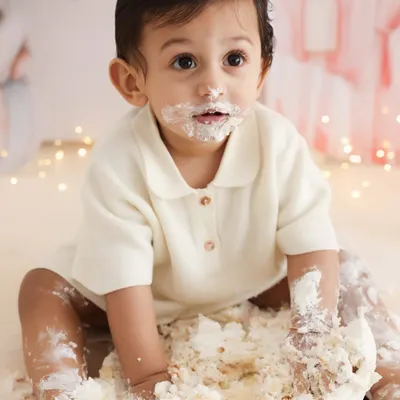 This is what a first birthday is all about. The pure, messy joy of digging into a cake for the first time. I love capturing the surprised expressions and happy giggles during my cake smash sessions.