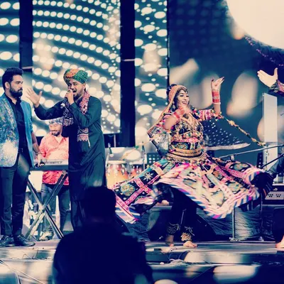 The entire troupe on stage, a beautiful chaos of color, music, and movement. This is the Gypsy Caravan in full swing, a true fusion of Spanish and Rajasthani gypsy traditions.