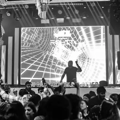 In the zone at Sugar Factory. The massive LED screen behind me is a key part of the visual experience, and I coordinate my set with stunning graphics to create an immersive party.