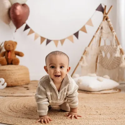 A classic crawling pose in our boho setup, perfect for capturing this adorable milestone.