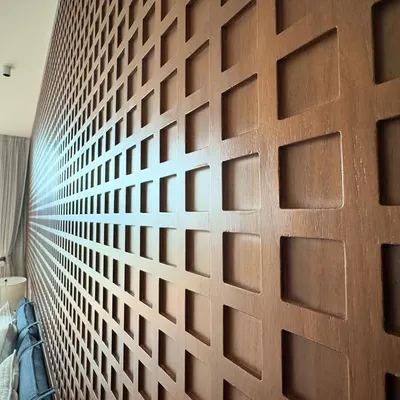 A detailed look at the custom CNC-cut wood paneling we created for a headboard. The repeating geometric pattern adds depth and a highly tactile quality to the bedroom wall.