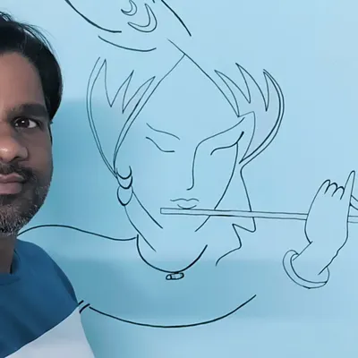 Here I am with a finished Radhe Krishna wall mural. I painted this directly on the wall for a client's home, creating a peaceful vibe with simple, modern line art. It’s amazing how a simple design can completely change a room.