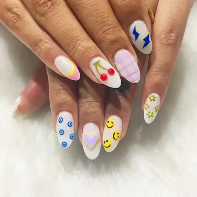 Why choose one design when you can have them all? This playful set on almond-shaped nails features a different hand-painted design on each finger, including smiley faces, cherries, evil eyes, and lightning bolts.