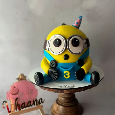 Here's Bob the Minion, ready for a birthday party. I sculpted this 3D cake entirely from fondant to capture his cute and surprised expression, complete with his little party hat.