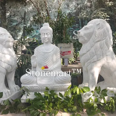This impressive setup features a 4-foot white marble Buddha statue guarded by two 4-foot hand-carved marble lions. Each lion weighs 500 kg, making this a truly grand statement for a hotel, resort, or farmhouse entrance.