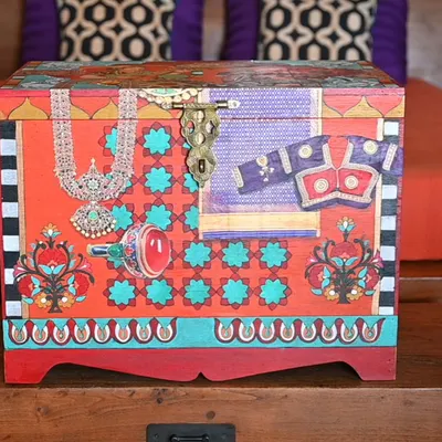 This handmade memory box, made from salvaged teak, is a tribute to the material culture of another era. The front panel features a collage of traditional Indian jewelry and textiles, perfect for storing your own treasures.
