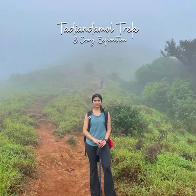 A trekker on the misty trail of Tadiandamol, the highest peak in Coorg. This easy-to-moderate 12 km trek is perfect for a weekend adventure.