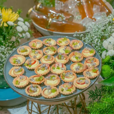 A platter of our fruit tarts, topped with fresh kiwi, dragon fruit, and plum. These dainty desserts are a refreshing and beautiful addition to any festive grazing table.