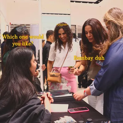 A candid moment from the TUMI event where guests are choosing their favorite city-themed luggage tag design. The "Bombay duh" choice was definitely a popular one among the crowd.