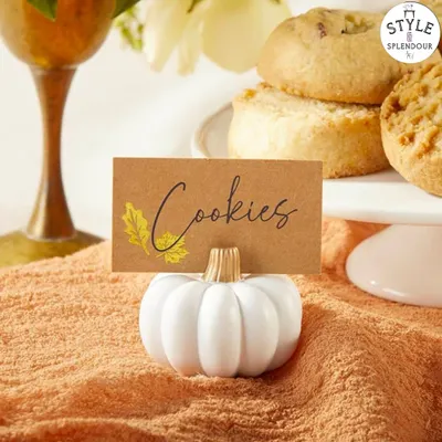 My white and gold pumpkin place card holders are incredibly versatile. Here, one is used to label "Cookies" on a dessert table, showing how they can organize a buffet spread with style.