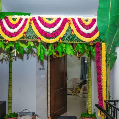 A traditional entrance chapra for a Gruhapravesam. I use real banana trunks, mango leaves, and garlands of marigold and chrysanthemums for an authentic and auspicious welcome.