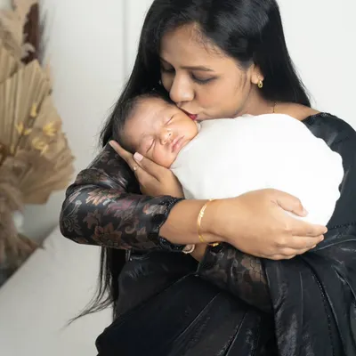 A mother's kiss is the purest form of love. This tender moment between a mom and her newborn is something she will cherish for a lifetime.