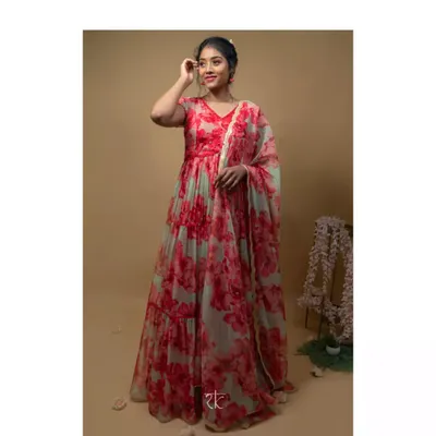 This layered organza gown in shades of red and pink is a floral dream. The cascading tiers create beautiful movement, and the scalloped dupatta adds a touch of delicate elegance.