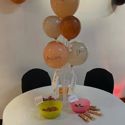 The details make the theme. For 'The Office' party, we created a centerpiece with poorly labeled balloons and bowls of snacks, a nod to the show's hilarious and understated party planning committee.
