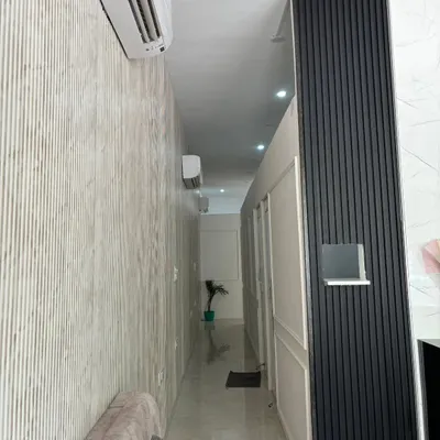 This is a view of the hallway in my clinic, showing the clean and calm atmosphere we maintain. A professional environment is key to building client trust and is an important part of the practice management I discuss in my courses.