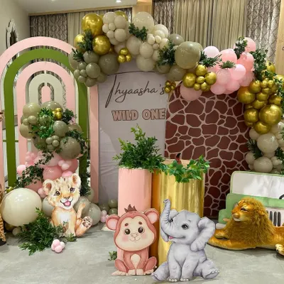 A closer look at our popular "Wild One" jungle theme birthday decoration. This setup is packed with details, including animal cutouts, lush greenery, and a personalized backdrop, making it a hit for first birthday parties.