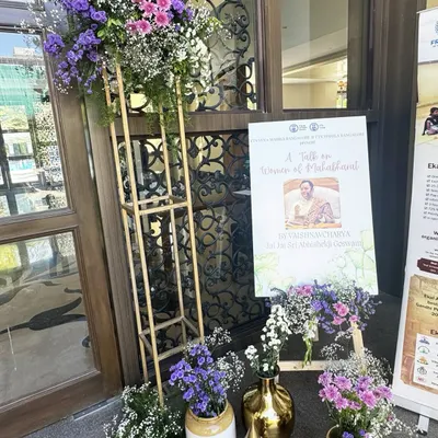 The entrance to this spiritual talk was designed to be a gentle welcome. We used an easel with a floral arrangement of purples and whites, paired with traditional brass vases, to set a tone of peaceful reverence from the very first step.