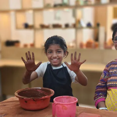 The pure joy of getting your hands messy with clay. This young participant can't hide her excitement during our one-day workshop, a perfect introduction to the world of pottery for all ages.