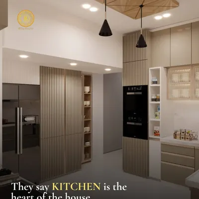 They say the kitchen is the heart of the house, and I design them accordingly. This space features seamless, fluted cabinetry, integrated appliances, and a unique wooden ceiling detail with pendant lights, blending warmth with modern efficiency.