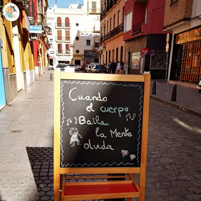 "Cuando el cuerpo baila, la mente olvida." This sign on a Sevillan street perfectly captures the spirit of our journey. It means, "When the body dances, the mind forgets." This is the feeling we chase in every class and every performance.