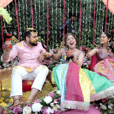 The joy of a Haldi ceremony is infectious. Here, friends and family shower the couple with flower petals and turmeric, and I capture the genuine laughter and vibrant colors of this beautiful pre-wedding ritual.