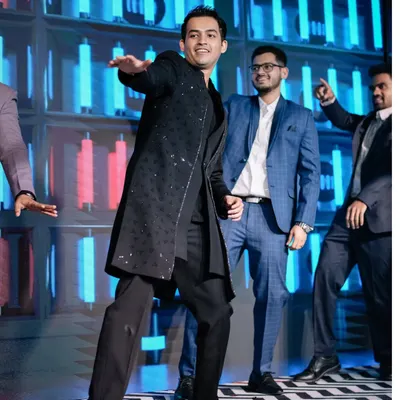 The groom takes center stage for his performance. We designed this dynamic LED backdrop and stage to make sure the groom's squad performance was a highlight of the Sangeet.