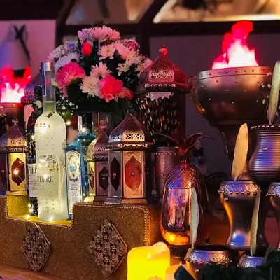 A glimpse into the luxurious ambiance of my Sufi-themed bar. The setup glows with warmth from Moroccan lanterns and dramatic flame bowls, creating an exotic and royal setting for your reception.