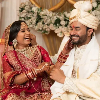 A candid moment of pure joy and laughter between the bride and groom. These are the unscripted memories we love to capture.