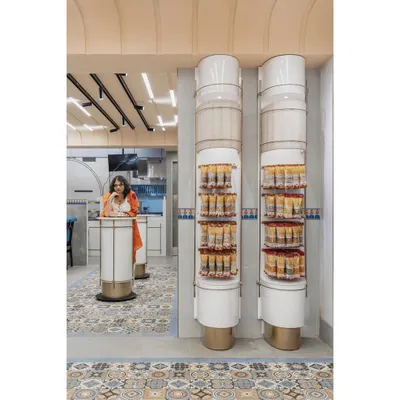 We deconstructed the form of a traditional Indian column to create these unique display and service units. Sliced vertically, it becomes a retail display; sliced horizontally, it serves as a standing table for customers.