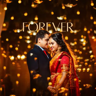 A magical and romantic portrait of a couple in traditional wedding attire, surrounded by glowing lights. The word 'Forever' perfectly captures the timeless emotion of this moment.