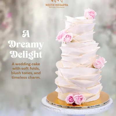 A dreamy delight for a timeless love story. This wedding cake features soft, hand-crafted folds, blush tones, and delicate pink roses, creating a sense of gentle movement and romance.