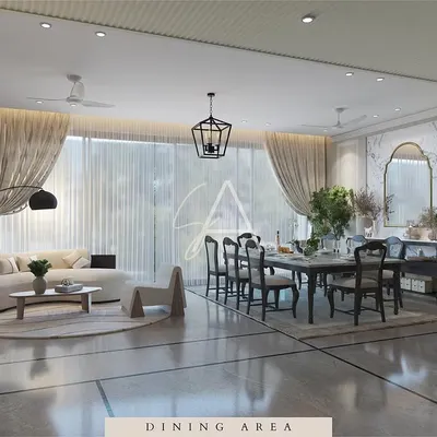 This open-plan living and dining area is designed for modern family life. A curved sofa defines the lounge space, while large windows and sheer curtains keep the entire area feeling bright, airy, and connected.