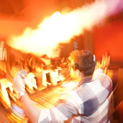 An abstract, high-energy shot capturing the explosion of sound and light during a peak moment. This is what the vibe feels like.