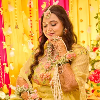 A serene portrait of the bride adorned with floral jewelry during her Haldi ceremony. I capture these quiet moments of beauty amidst the joyful chaos of the event.