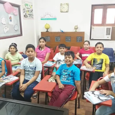 This is a typical classroom session for our young learners. You can see the engaged and positive atmosphere we cultivate, where children feel comfortable interacting with their peers and teachers while improving their English communication skills.