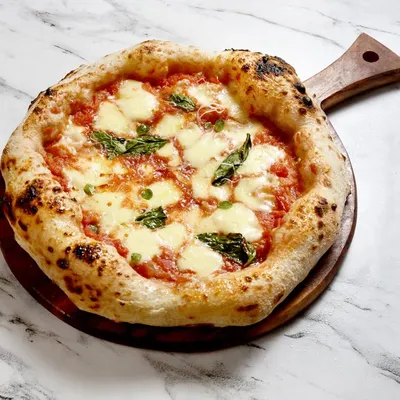 Meet the queen, a classic Pizza Margherita. Made with San Marzano tomatoes, fresh mozzarella, and basil on my signature airy crust, it's simple, elegant, and incredibly delicious.