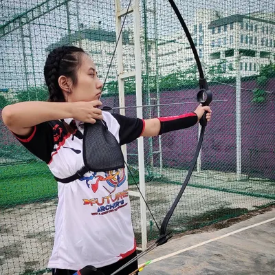 This is perfect archery form in action. An archer from our academy demonstrates a full draw, with solid posture and intense focus, showcasing the high level of technical skill we cultivate.