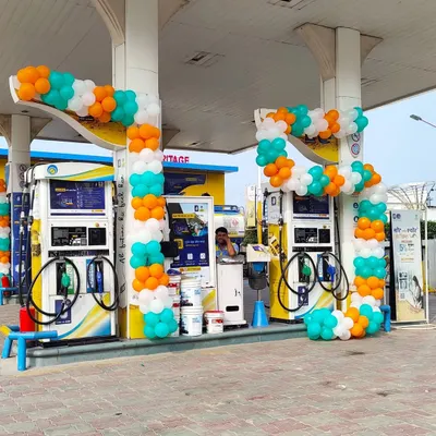 A custom-shaped balloon garland for a petrol pump in Noida. This tricolor design wraps around the fuel dispensers for an Independence Day event.