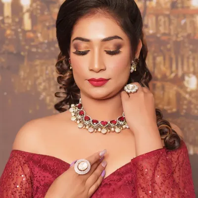A close-up of this glamorous reception look. We went for a warm, blended smokey eye, flawless airbrushed-finish skin, and a classic red lip. The focus is on creating a sophisticated and polished look that lasts all night.