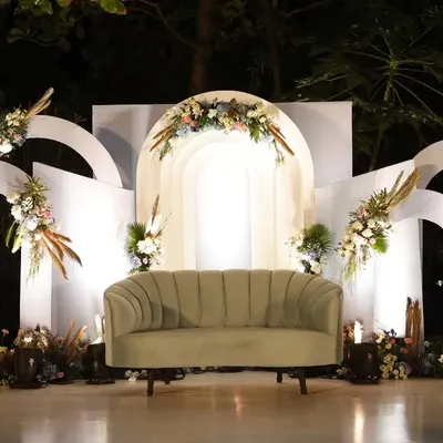 A beautiful stage we designed for Ezekiel's First Holy Communion. The modern white arches are softened with bohemian-style floral arrangements featuring pampas grass, creating a look that is both contemporary and serene.