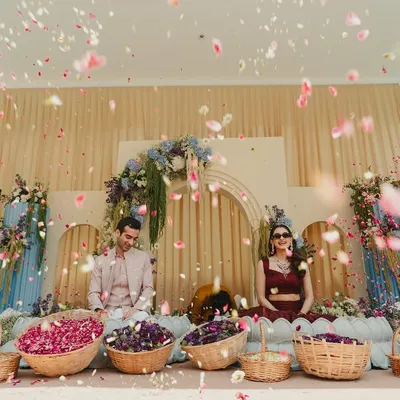 This is the moment it all comes together. A 'Petals of Joy' Haldi ceremony, where the couple is showered with blessings and flowers by their loved ones against a backdrop of soft pastels and cascading florals.