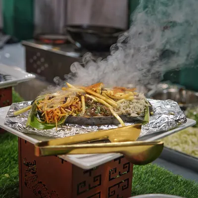 Sizzling platters speak louder than words. A freshly prepared sizzler, steaming and packed with flavor, ready to be served hot off the grill at your event.