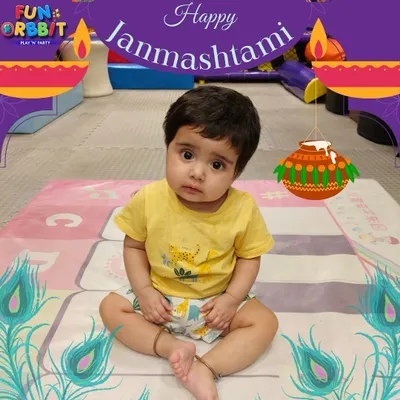 An adorable little one celebrating Janmashtami with us. Our themed setup with festive graphics provides a cute and safe space for toddlers to enjoy the celebration.