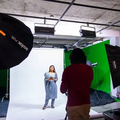 On set for a commercial ad shoot, managing a green and white screen setup. This shows the scale of production I handle, complete with professional lighting and a dedicated space for client monitoring.