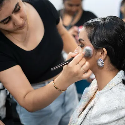 A candid moment of me doing what I love most. This shot was taken backstage at a fashion show, where I'm adding the finishing touches to a model's makeup.