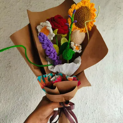 I love making these mixed bouquets because they are so full of life and color. This one combines a sunflower, rose, daisy, and lavender, all wrapped in rustic kraft paper.